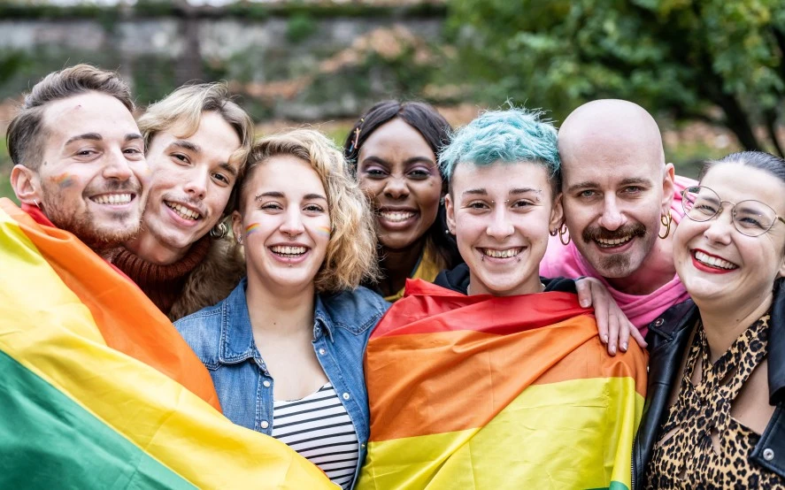 Group of people holding an LGBTI+ flag